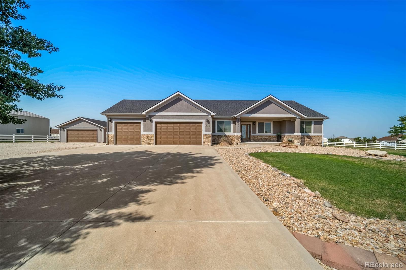 Aerial view of the ranch property in Brighton Colorado with open fields and space